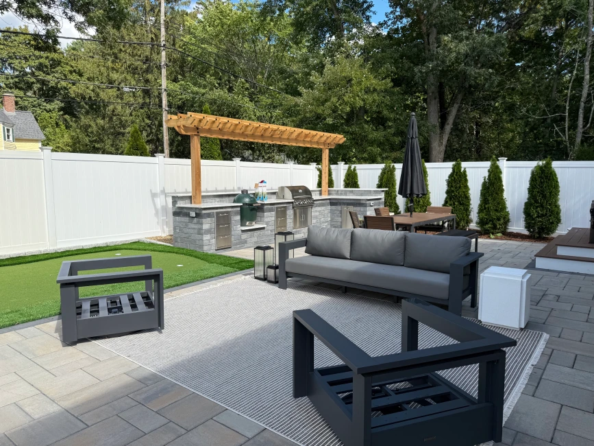 Outdoor kitchen with pergola and lounge set