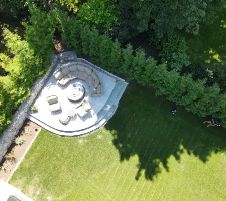 Aerial sod lawn installation Massachusetts curved paver patio seating area trees