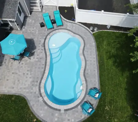 Aerial sod lawn installation Massachusetts pool paver patio turquoise furniture