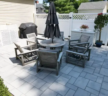 Backyard paver patio with outdoor dining area and BBQ grill in Massachusetts