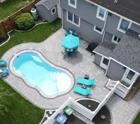Backyard pool with patio furniture