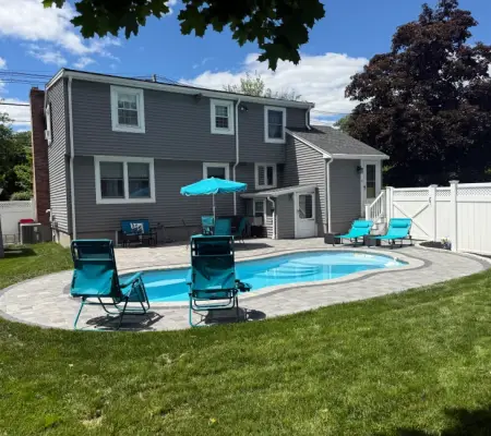 Backyard swimming pool with custom paver patio Wellesley MA