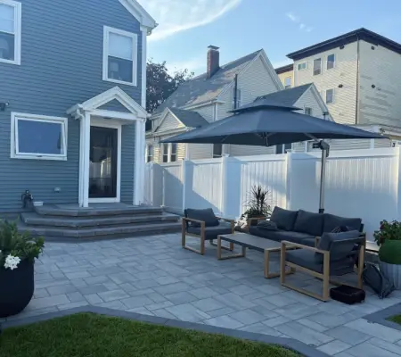 Blue home patio with seating and umbrella