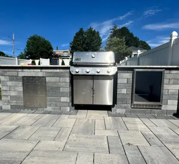 Built-in outdoor kitchen stainless steel grill stone veneer counter Winchester MA paver patio hardscape