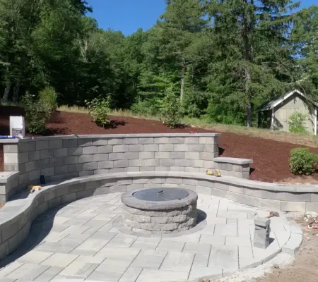 Curved seat wall with stone fire pit, Concord MA outdoor sitting area