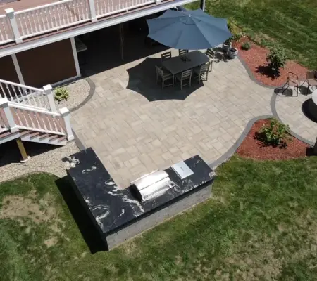Aerial view paver patio fire pit seating area outdoor dining Winchester MA backyard hardscape design