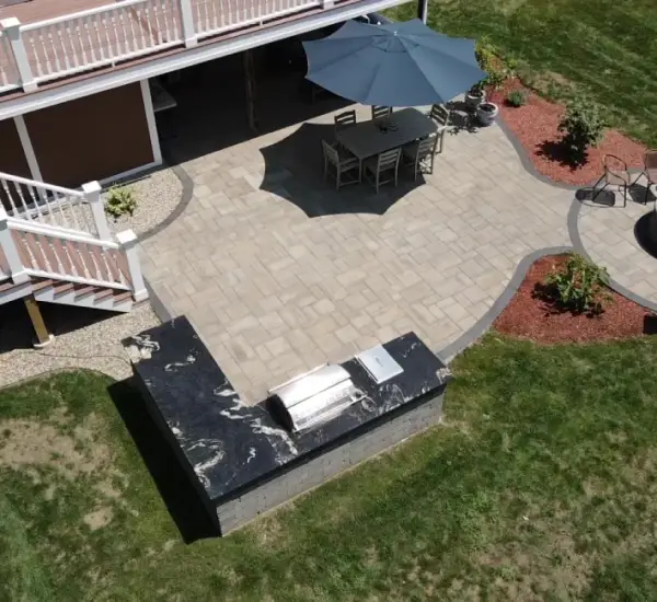 Aerial view paver patio fire pit seating area outdoor dining Winchester MA backyard hardscape design
