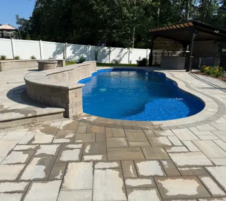 Custom pool with stone patio and pavilion