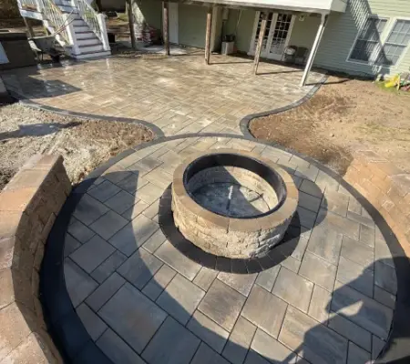 Custom stone fire pit and paver patio in Massachusetts