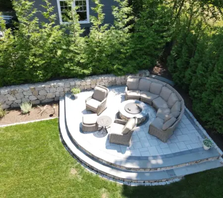 Drone view of curved stone seat wall surrounding fire pit area