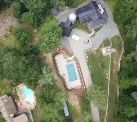 Drone view of luxury estate with two pools