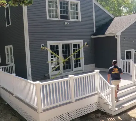 Elevated backyard deck with white railings Essex MA