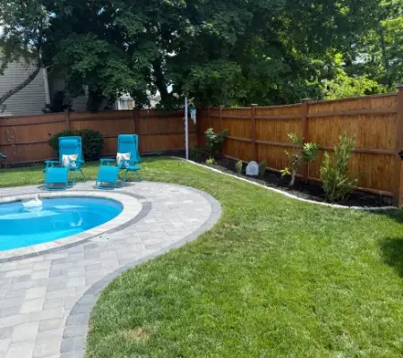 Fresh sod installation Massachusetts pool patio paver surround cedar fence
