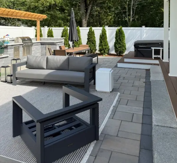 Modern paver patio outdoor kitchen lounge seating white fence Winchester MA contemporary hardscape design