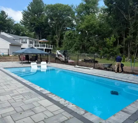 Pool with patio, canopy, and safety fence