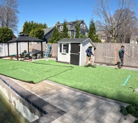 Professional artificial turf installation Massachusetts crew paver surround pool deck