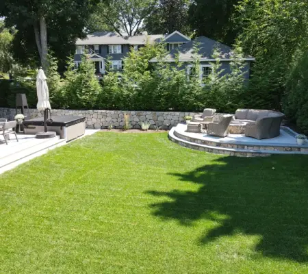 Professional sod installation Massachusetts luxury estate stone wall patio hot tub