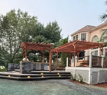 Twin cedar pergolas, Lexington MA stone fireplace patio
