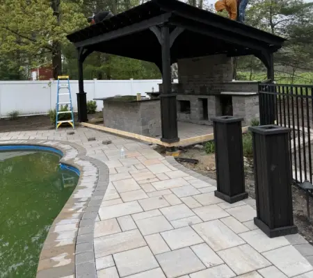 Workers building poolside pavilion ma