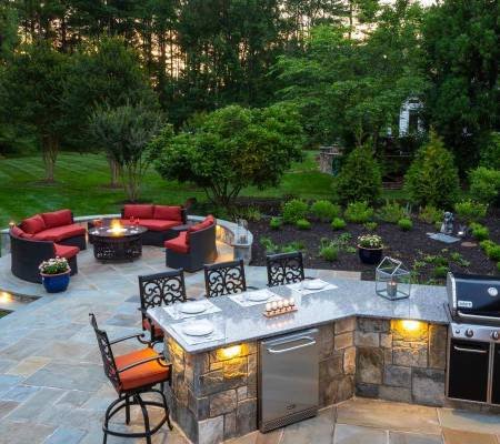 outdoor kitchen with lighting and fire pit